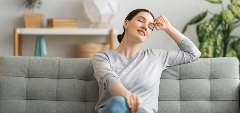 Portrait of beautiful woman resting on sofa at home